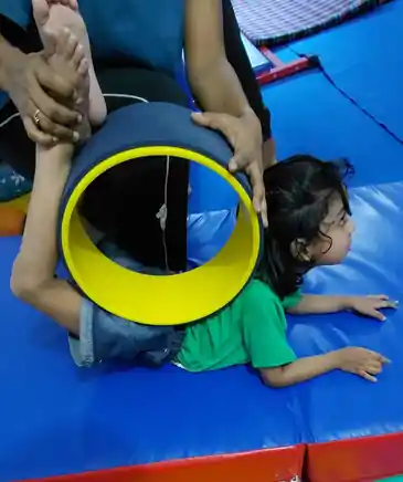 Child in a guided physical training session with a coach at Rajeev Nagar, Patna
