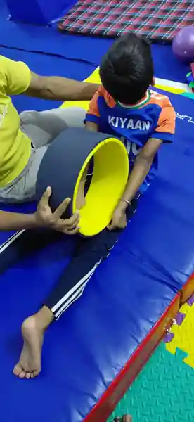 Boy in a split stretch during flexibility training at our Patna gymnastics centre, Rajeev Nagar