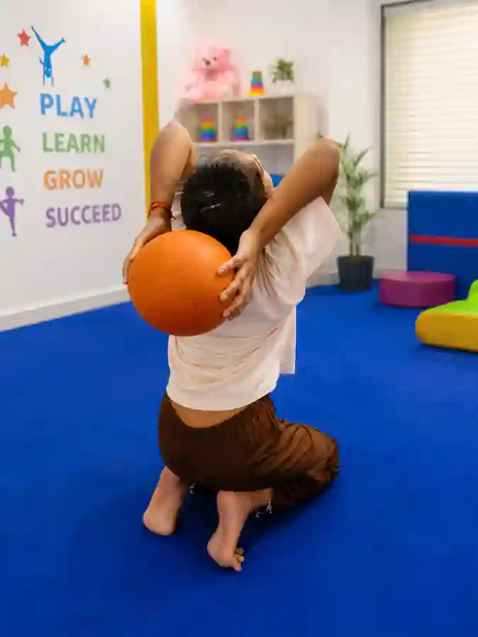 Girl working with a soft training ball during a gymnastics class in Rajeev Nagar, Patna