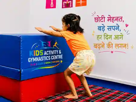 Girl climbing a wall ladder during a kids gymnastics session at our Patna centre