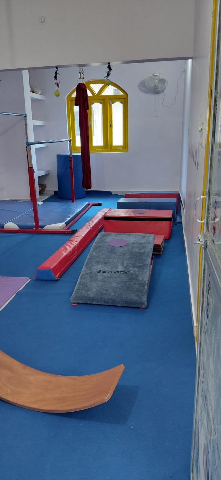 Gymnastics bars, padded mats and training equipment in the centre
